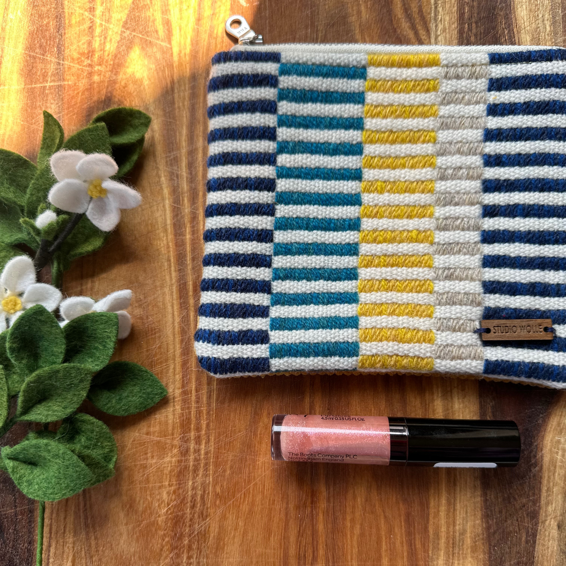 Blue, Turquoise and Yellow Striped Purse with a lipstick for scale